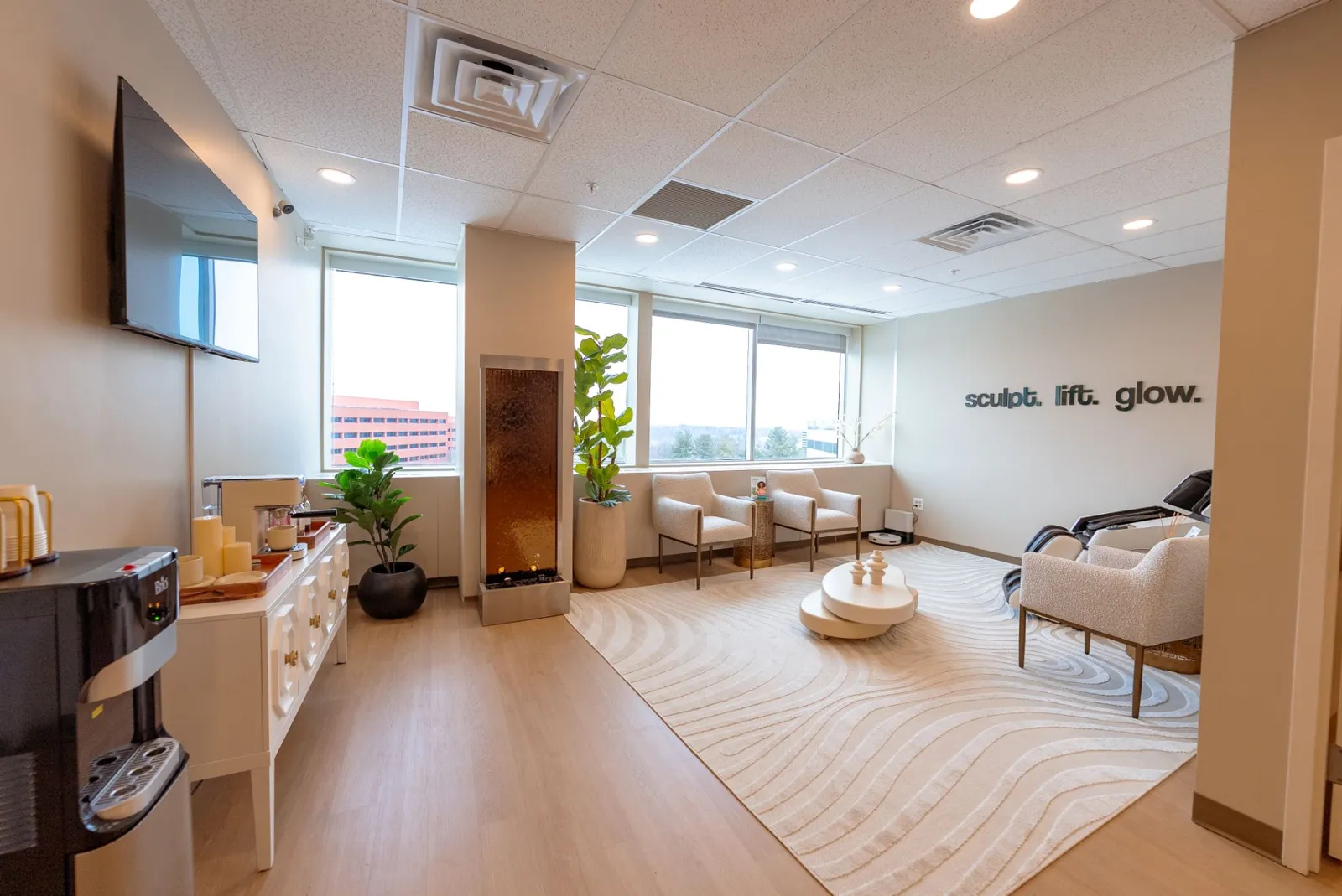 The Nuvera client lounge with a water wall and refreshment bar