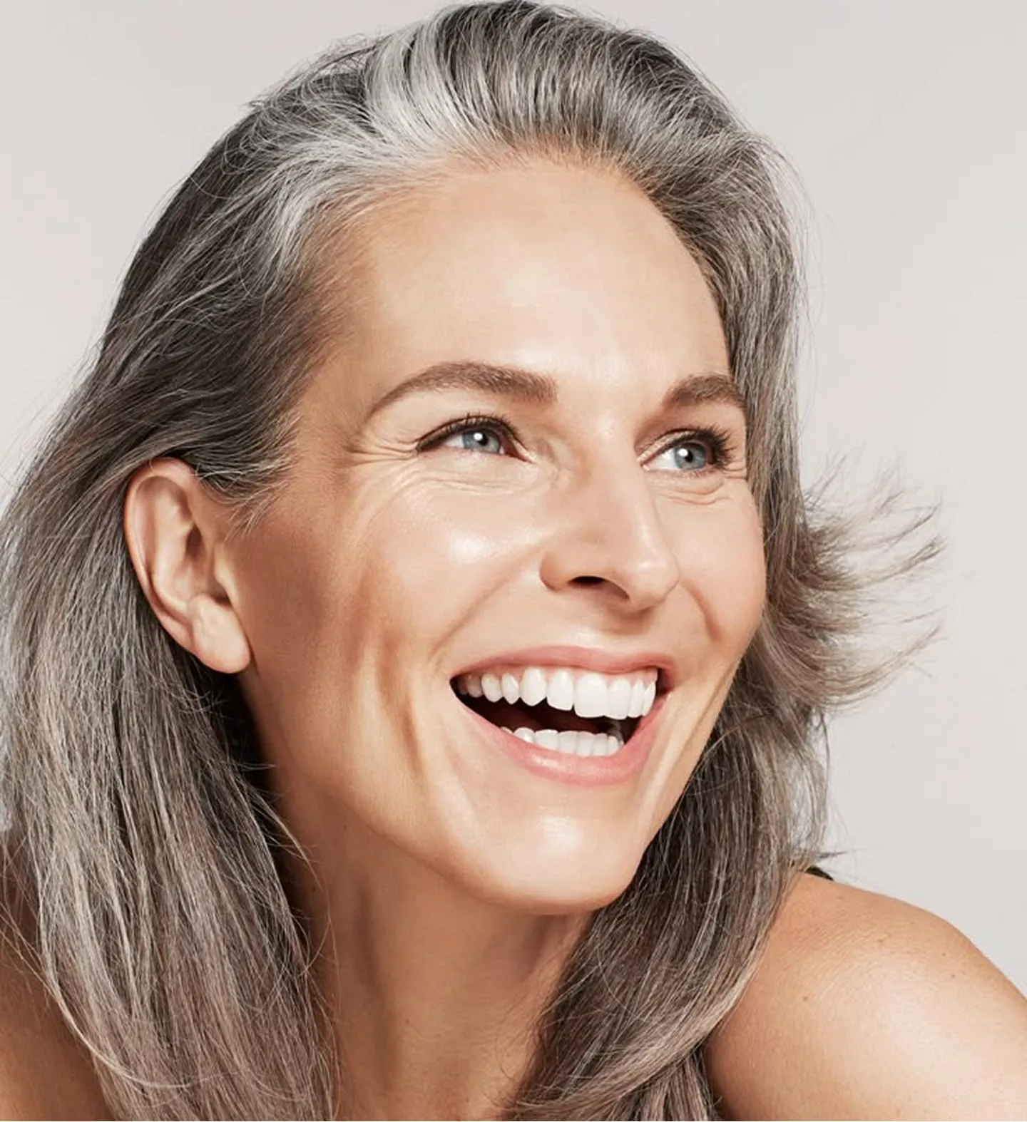 A smiling woman with glowing skin